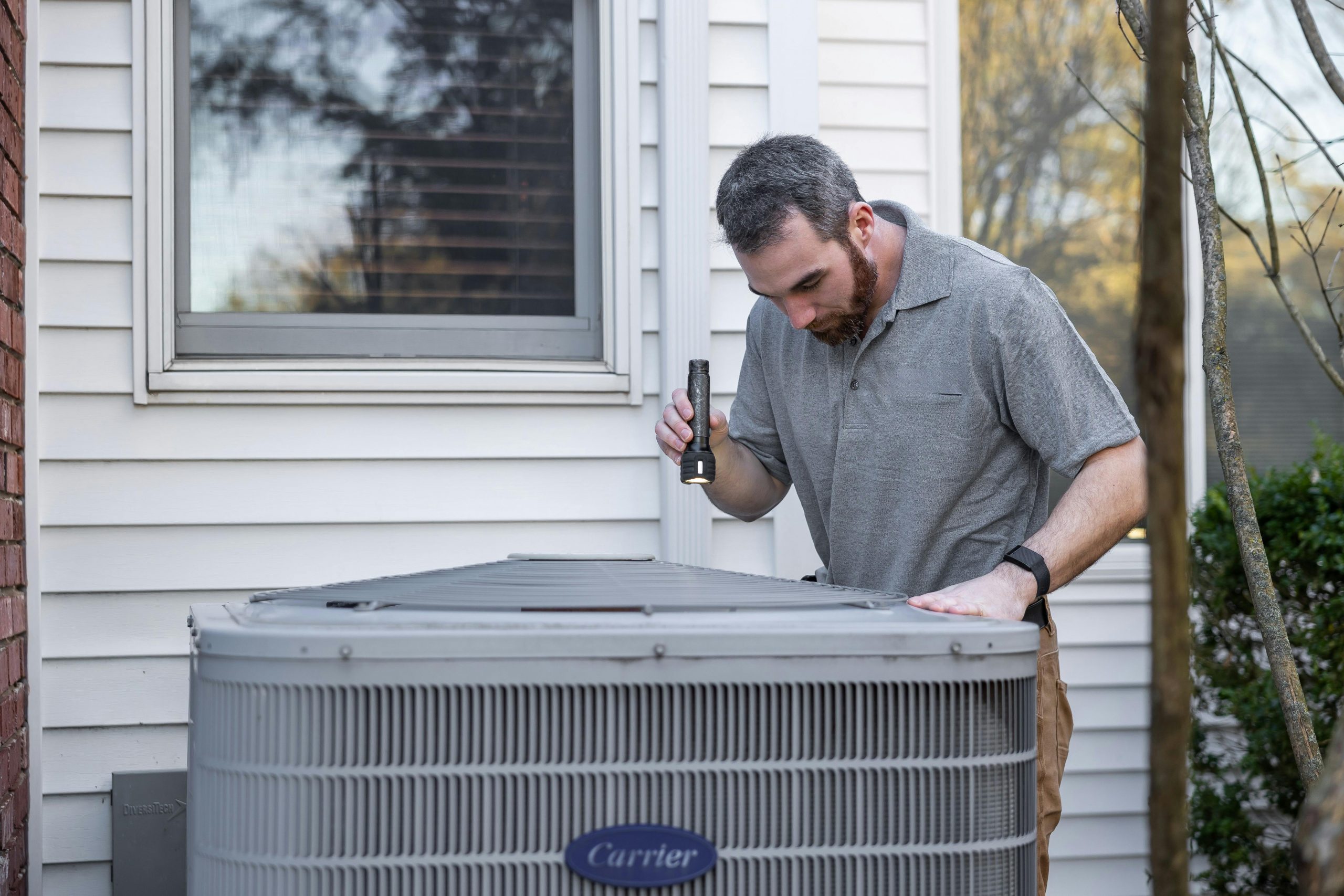 contractor inspecting an HVAC unit
